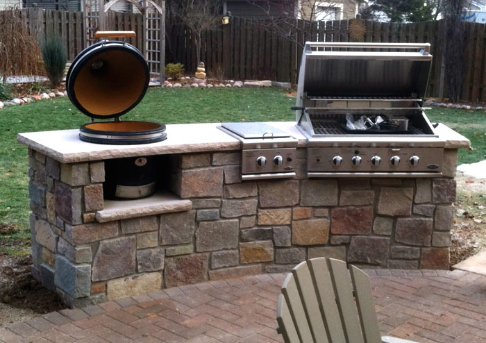 custom concord style outdoor kitchen with two grills