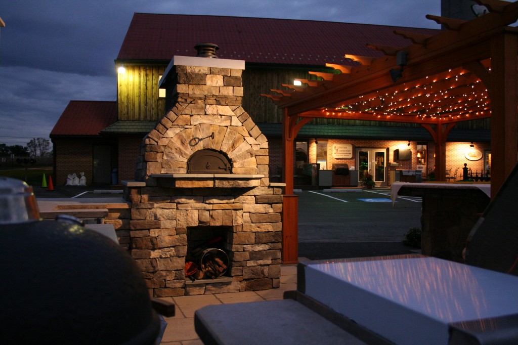 Wood Fired Oven next to home illuminated at night