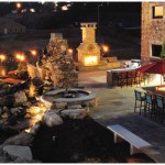 outdoor kitchen and patio area shown at night