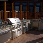 outdoor kitchen space with several stainless steel appliances and grill