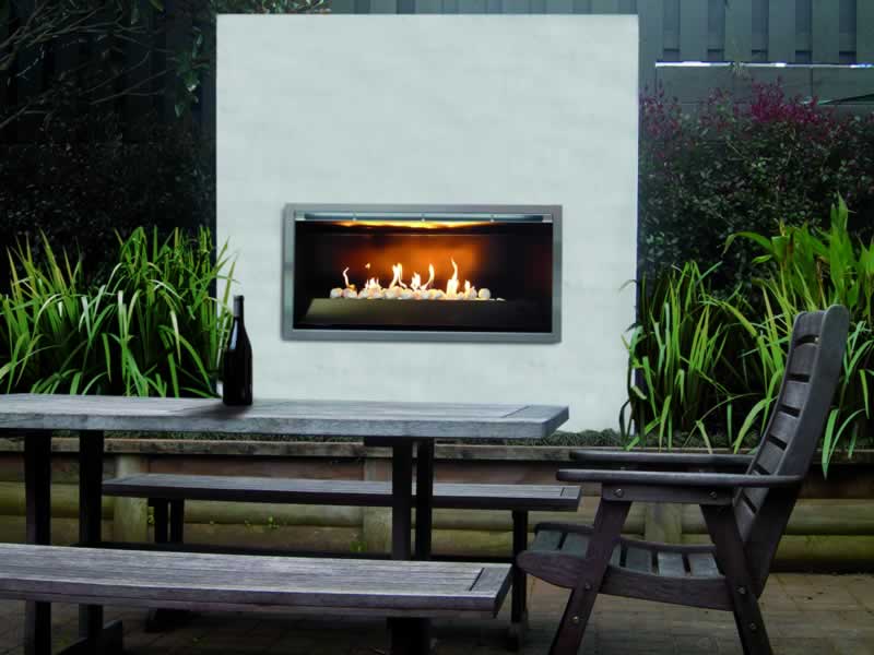 Rinnai Impression Single Sided outdoor gas fireplace with chair and in black picnic table in front of it